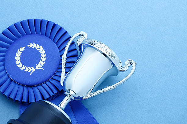 A trophy lying on a blue ribbon.To see similar images click on the link below:
