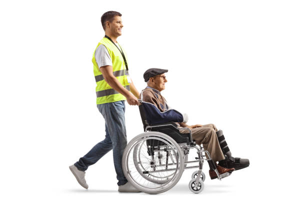 istock Security guard pushing injured man in a wheelchair 1841389220