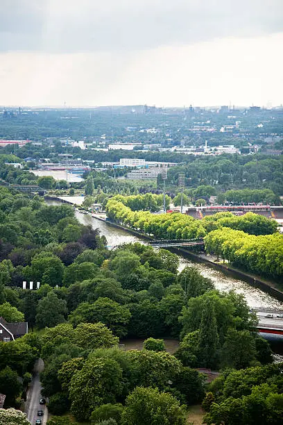 view over Oberhausen, with Rhein-Herne Kanal, highway (A42) and industrial buildings, seen from the roof of the Gasometer, which was formerly used to store gas, and is today a place where exhibitions take place and to allow visitor a view over the Ruhr area