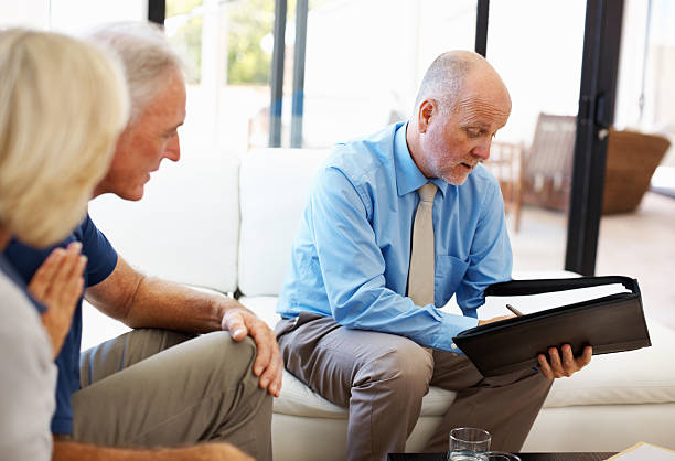 istock Male financial planner explaining to elderly couple 184139547