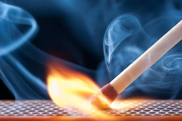 Matchstick igniting into flame