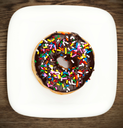 Delicious fresh chocolate donut on a plate.