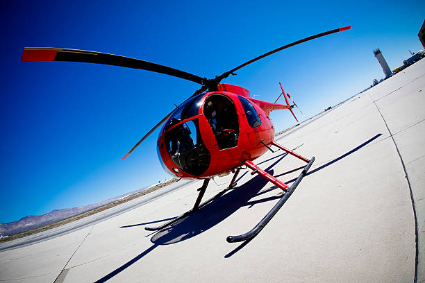 istock Red helicopter landing on sunny day 184140539