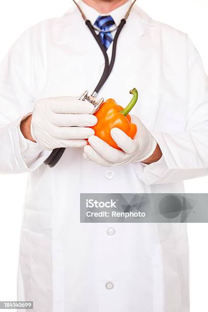 Doctor Examining Orange Bell Pepper Stock Photo - Download Image Now - Bell Pepper, Clean, Concepts