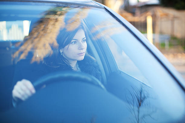 istock Young serious woman is driving a car 184140828
