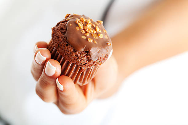 istock Chocolate muffin in woman's hand 184141184