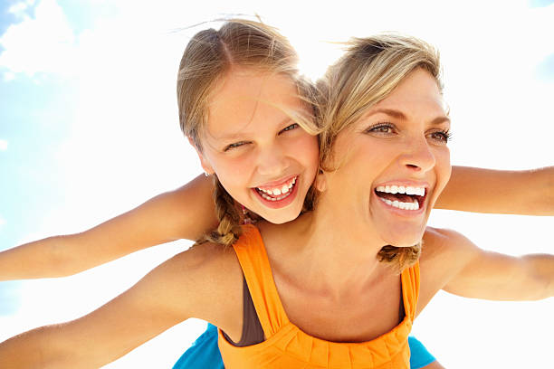 istock Girl enjoying a back ride on cheerful mother 184141264