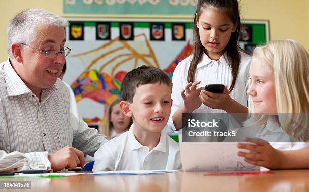 Junior School Education Matters Stock Photo - Download Image Now - 40-49 Years, 8-9 Years, Adult