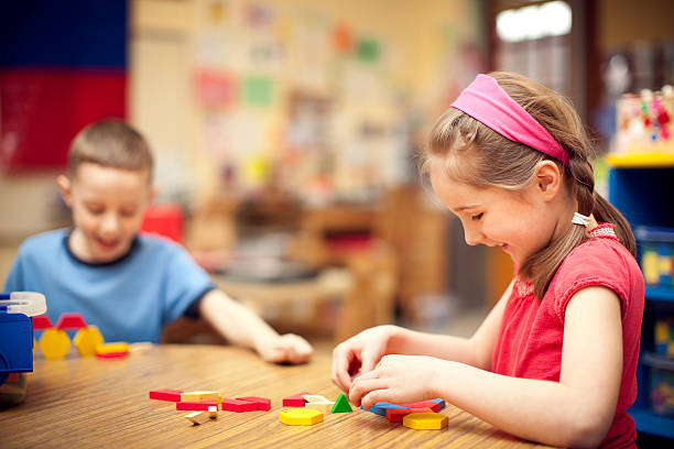 istock Boy and Girl Students Playing with Toy Blocks at School 184142180