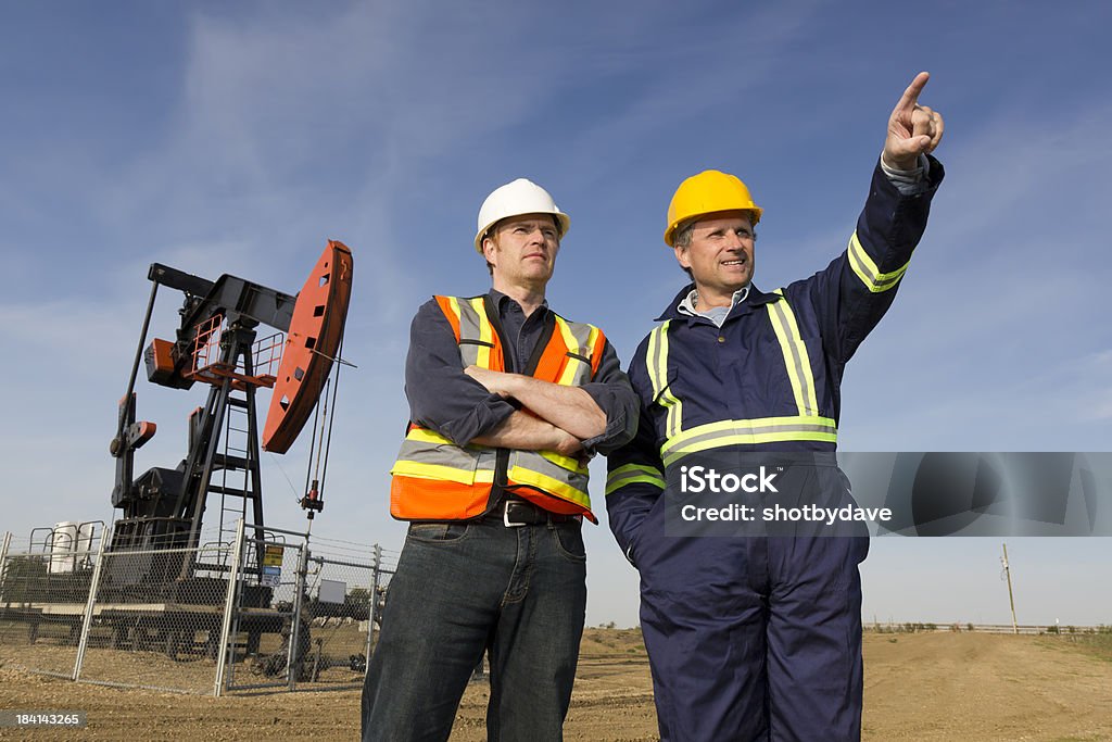 Pointing it Out An image from the oil industry of an engineer and oil worker having a discussion. Gasoline Stock Photo