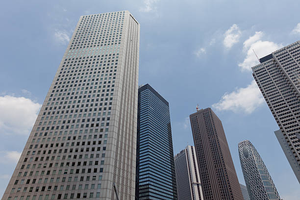Skyscraper District in Tokyo, Japan "From left to right, Shinjuku Sumitomo Building , Shinjuku Mitsui Building , Shinjuku Sompo Japan Building , Shinjuku Center Building , Mode Gakuen Cocoon Tower , Keio Plaza Hotel." low angle street japan stock pictures, royalty-free photos & images