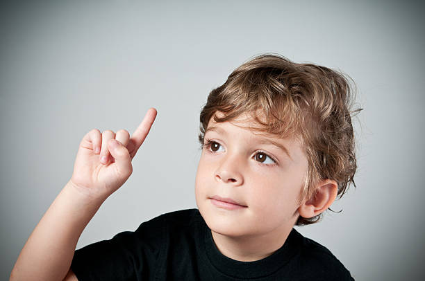 istock kid making the one gesture like asking or answering something 184143799