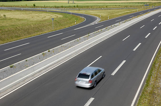 istock Straight highway with one silver car 184144147