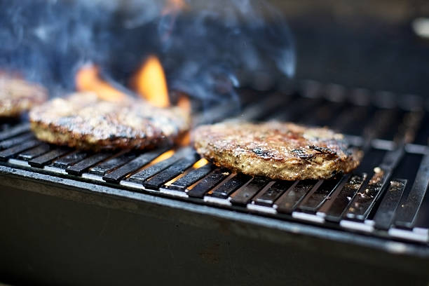istock hamburger patties on bbq grill 184144194