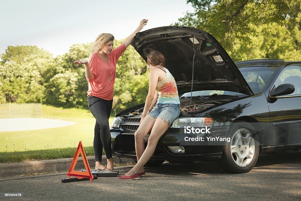 Travelers Having Car Problem Needing Emergency Repair Service Hz "Two young women distressed travelers having car troubles on the road, discussing their options." 20-29 Years Stock Photo