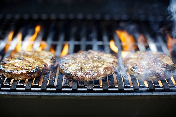 istock hamburger patties on bbq grill 184144543