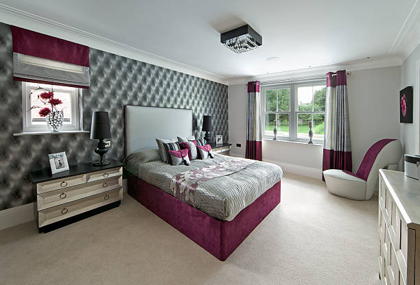 elegant girl's bedroom "An elegant bedroom in an expensive new house tastefully dressed by a leading interior designer as a girl's room. The cushions, bedcover and headboard together with the curtains and blinds are all silk, in silver-grey and dark pink. The chests of drawers have a metallic finish with a hint of cream to blend with the beige carpet. Artwork and pictures are from my portfolio on iStock and have model releases as appropriate.Looking for a Bedroom image Then please see my other Bedrooms and related images by clicking on the Lightbox link below..." red cushion covers stock pictures, royalty-free photos & images