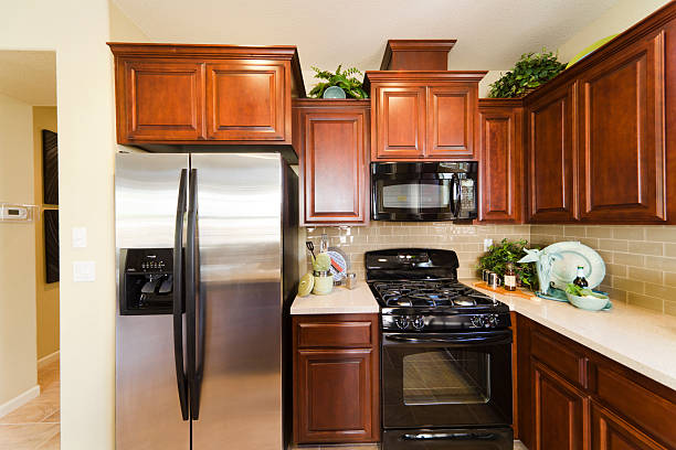 istock Modern American kitchen with brown cabinets and appliances. 184144618