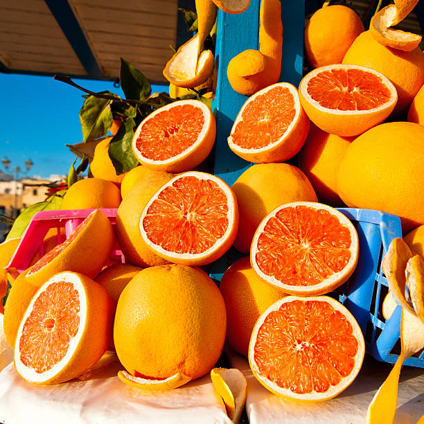 Orange Juice Market Stall Morocco "Oranges on a typical market stall - orange juice stand - ready for a freshly squeezed orange juice. Djemaa el Fna Square, Marrakesh, Morocco, North Africa. Squared." valencia orange stock pictures, royalty-free photos & images