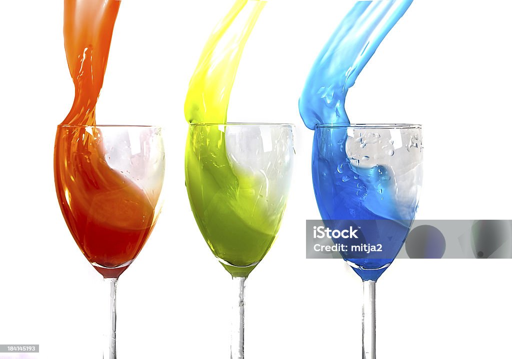 RGB splash Conceptual image of Red Green and Blue liquid splashing out of a glass isolated on a white background. Art Stock Photo