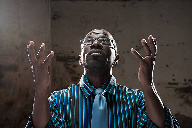 looking up with open hands stock photo