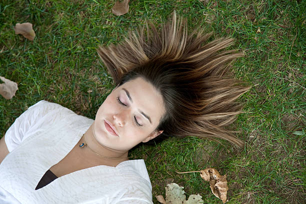 istock Young girl Lying on grass 184146628