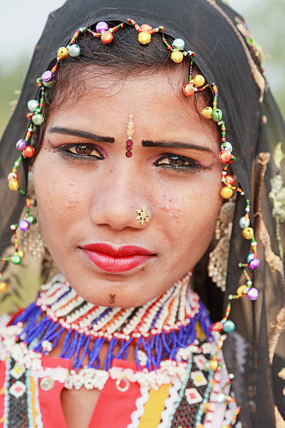 Tribal Woman Rajasthan India "Portrait of a traditional young Rajasthani woman with tribal tatoo, tiki mark on forehead, jewelery and clothing of Rajasthan . Near Pushkar, India" india indigenous culture indian culture women stock pictures, royalty-free photos & images