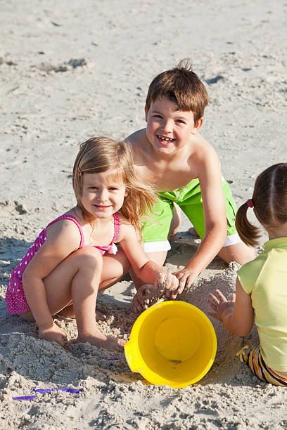istock Children playing in sand on beach 184147124