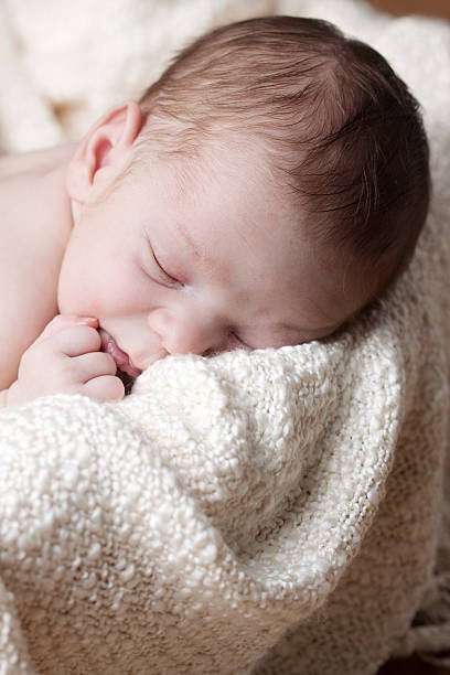 istock Newborn Baby Sleeping in Basket 184147224