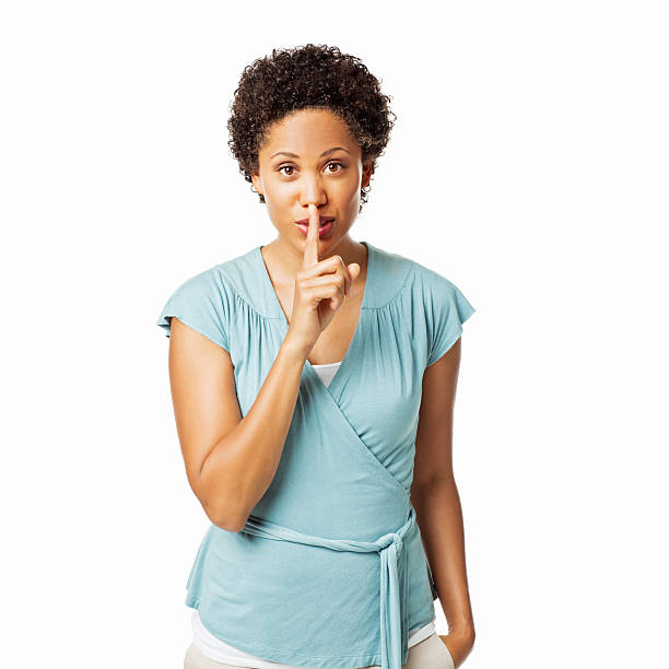 istock Attractive Woman Shushing the Camera - Isolated 184147525