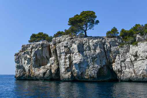 Calanque de Figuerolles, a snug cove framed by rugged cliffs in France.