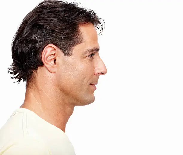Profile view of handsome man looking away on white background