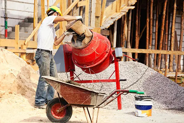 Photo of Bricklayer and concrete mixer