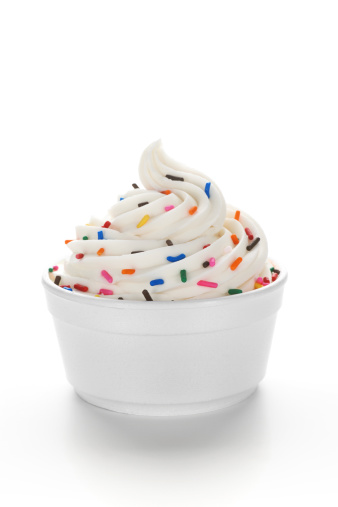 Single serving of frozen yogurt (or soft serve ice cream) with sprinkles in a standard disposable restaurant portion cup.