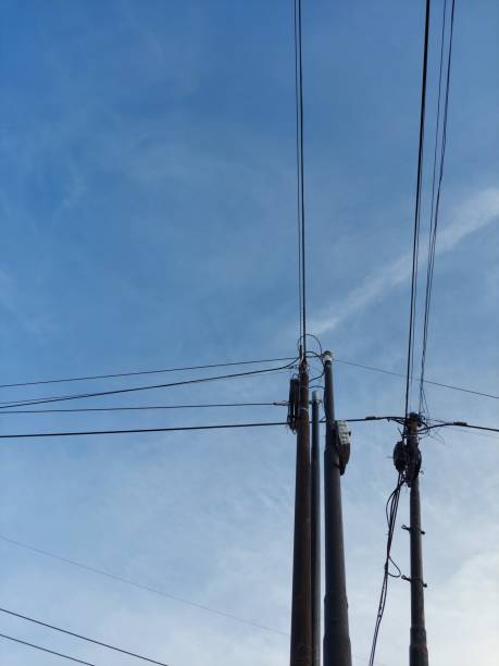 istock Electric power pole and telephone pole with blue sky background 1841488984