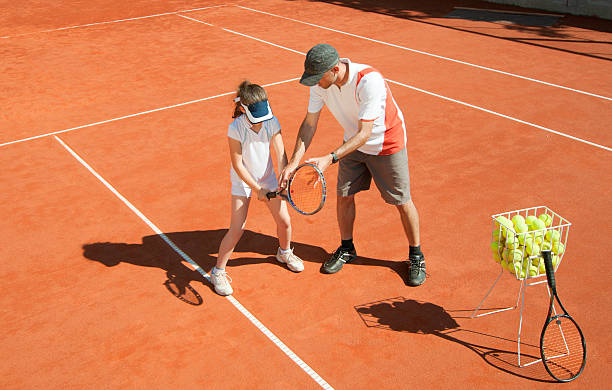 istock Tennis coach with talented young girl 184148927