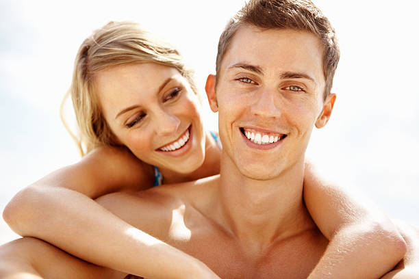 istock Young woman embracing man outdoors 184149108