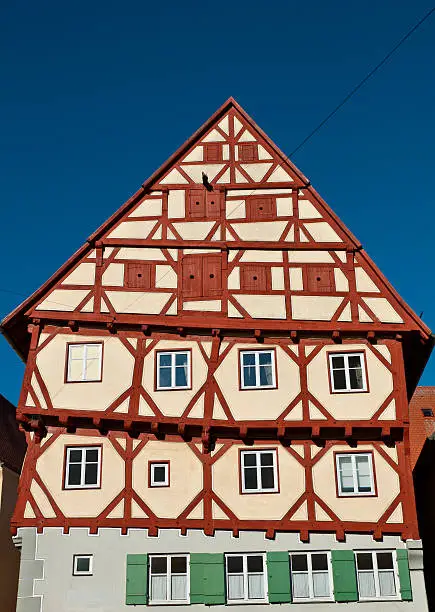 "Ancient half-timbered house in NArdlingen,( Swabia, Bavaria, Germany ). This crooked house (no lens distortion) was built in the 14th century and completely restored 1983 - 1984. An impressing timber construction."
