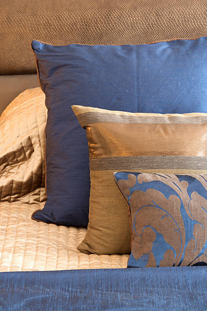 blue and gold silk cushions blue and gold silk cushions sitting on a bed. A gold coloured bed spread and headboard are in the background with a blue silk band in the foreground.Looking for more images of cushions Then please click on the Lightbox link below...A>A head board bed blue stock pictures, royalty-free photos & images