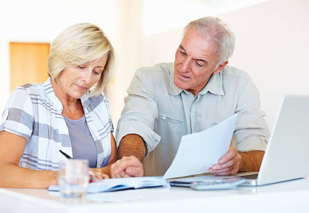 istock Senior couple calculating monthly expenses 184150888