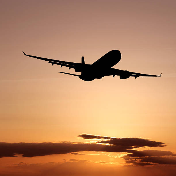 istock XL jet airplane taking off at sunset 184151376