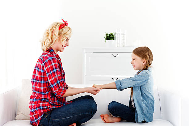Mother and Daughter Holding Hands Playfully stock photo