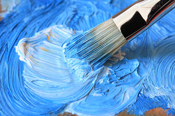 Paintbrush with blue oil paint on a classical palette Paintbrush with blue oil paint on a classical palette- OTHER artists materials related photos: oil paint palette stock pictures, royalty-free photos & images