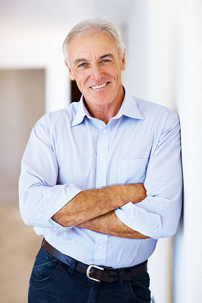 istock Senior man standing with arms crossed 184152494