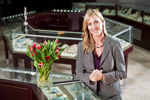 Shopper or saleswoman, 40s, in jewelry store.