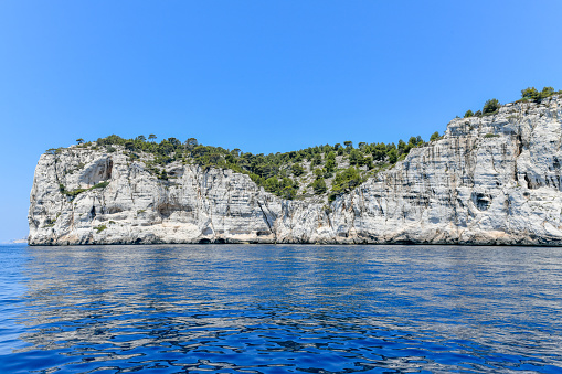 Calanque de Figuerolles, a snug cove framed by rugged cliffs in France.