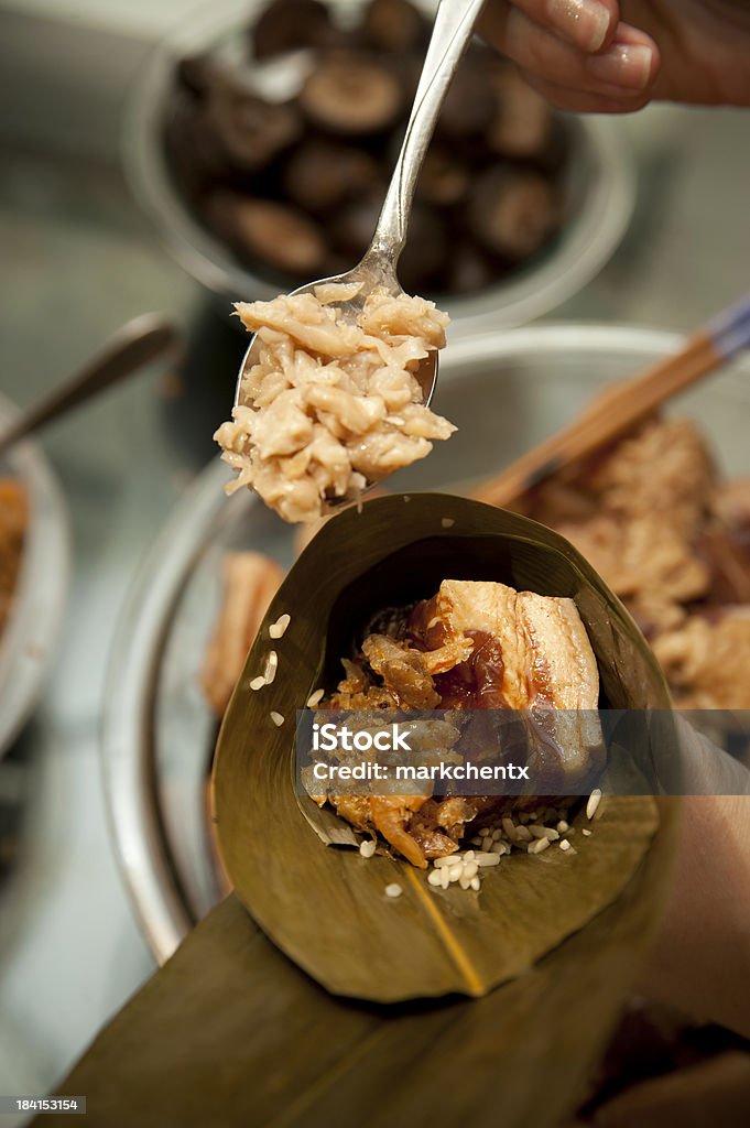 Wrapping Rice Dumpling Close up of rice dumpling in the making Bamboo Leaf Stock Photo