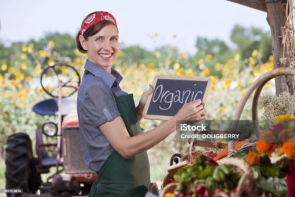 Organic Farmer Woman selling organic produce at Farmers Marketplease see similar images in my portfolio 50-59 Years Stock Photo