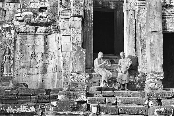 Studying monks in Siem Reap "Monks studying together in Siem Reap. Bayon temple.note Silver Efex, grain added" black and white travel travel destinations monk stock pictures, royalty-free photos & images