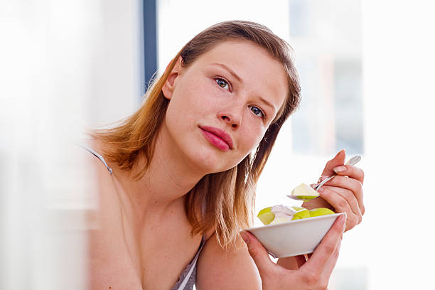 istock Young woman eating a heathly meal 184154206
